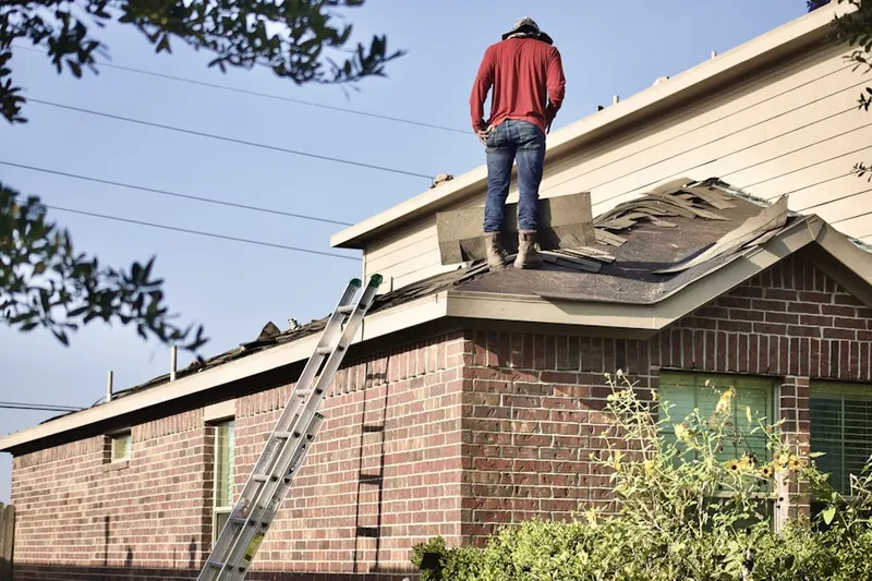 Professional roofer working on a residential roof in Belle Glade